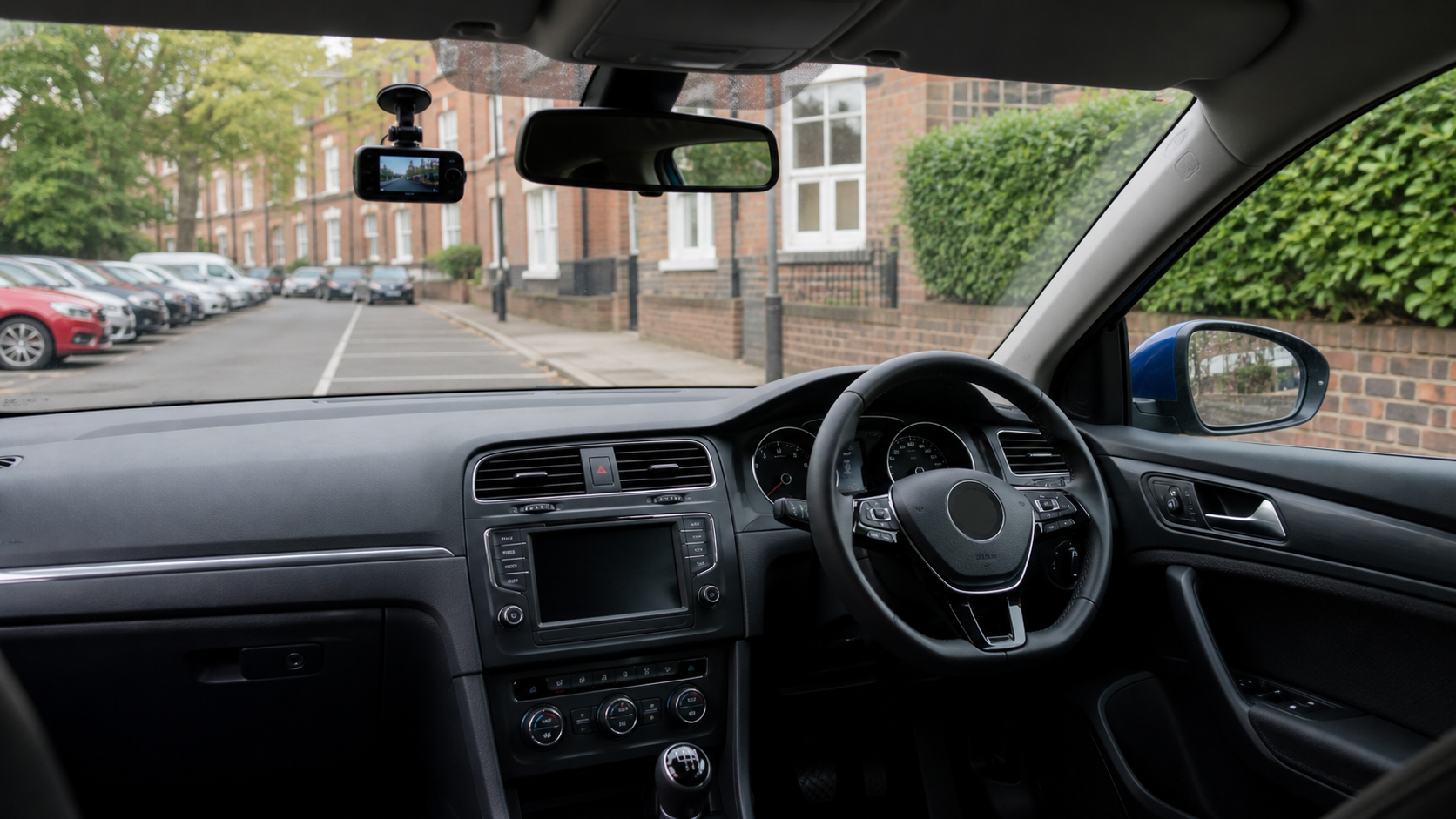 Dash cam installed in a tidy business-style car interior.